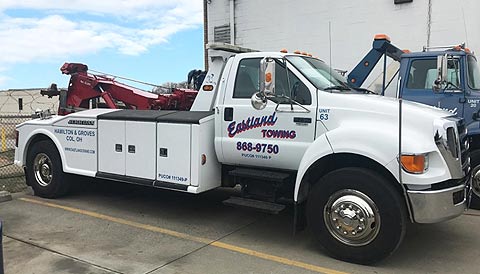 Eastland Towing medium-duty wrecker with hydraulic extendable boom.