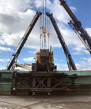Up-righting an electrical truck using a 45 ton wrecker and a crane to flip in mid-air.