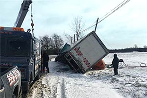 Using an air cushion to up-right a tractor trailer truck.